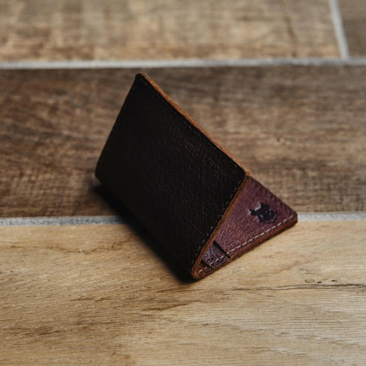 Brown leather wallet on a wooden surface