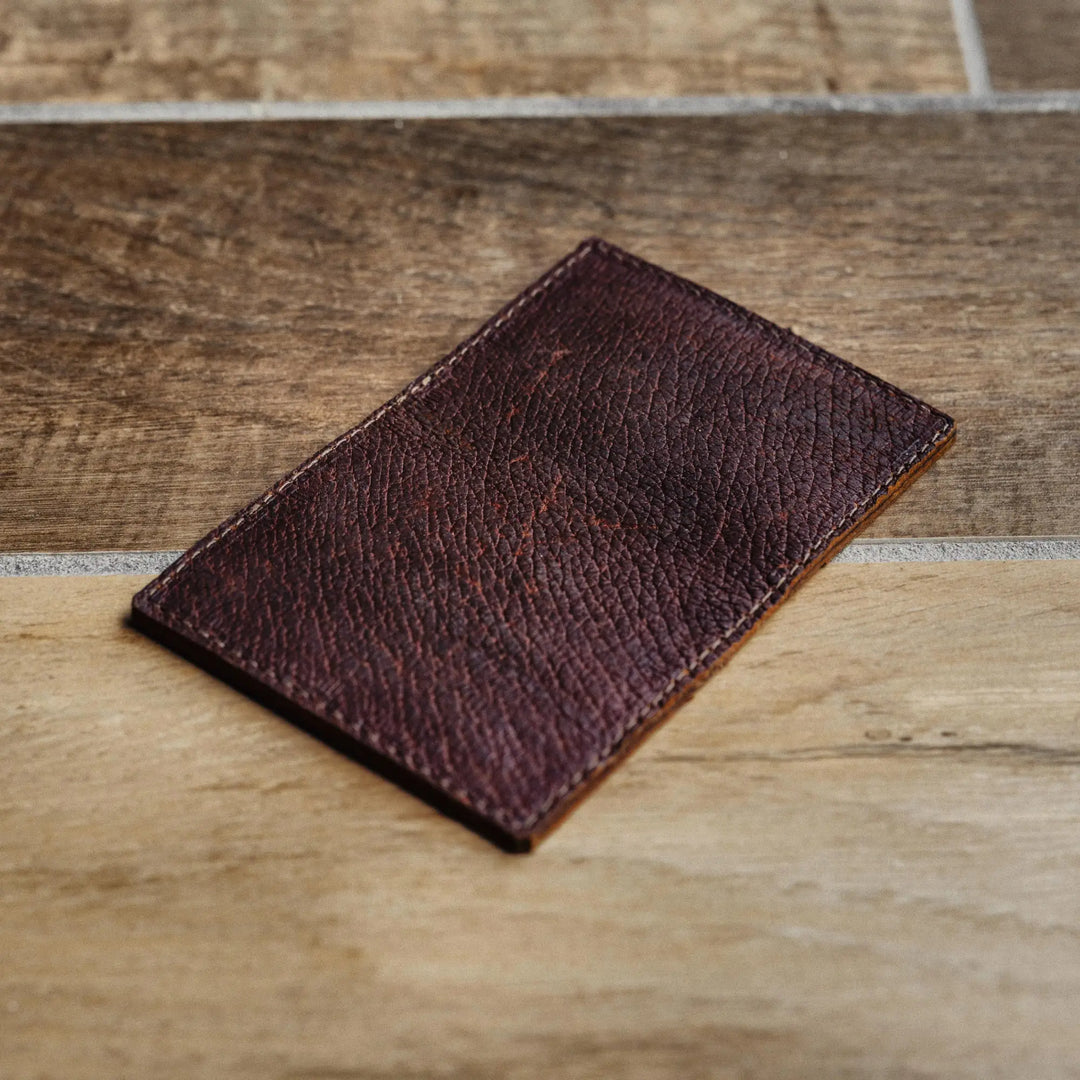 Brown leather wallet on a wooden surface