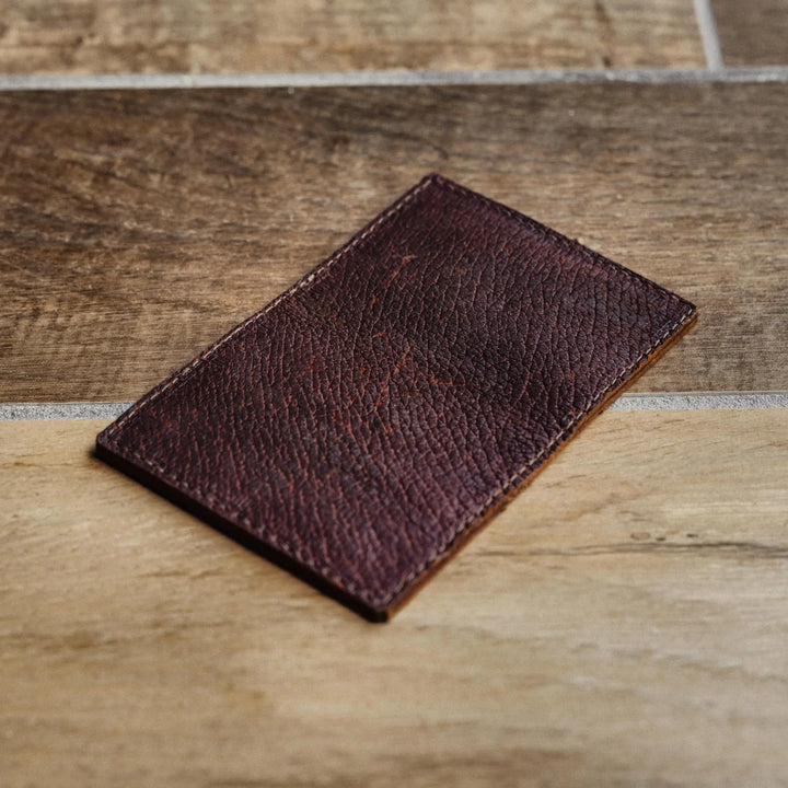 Brown leather wallet on a wooden surface