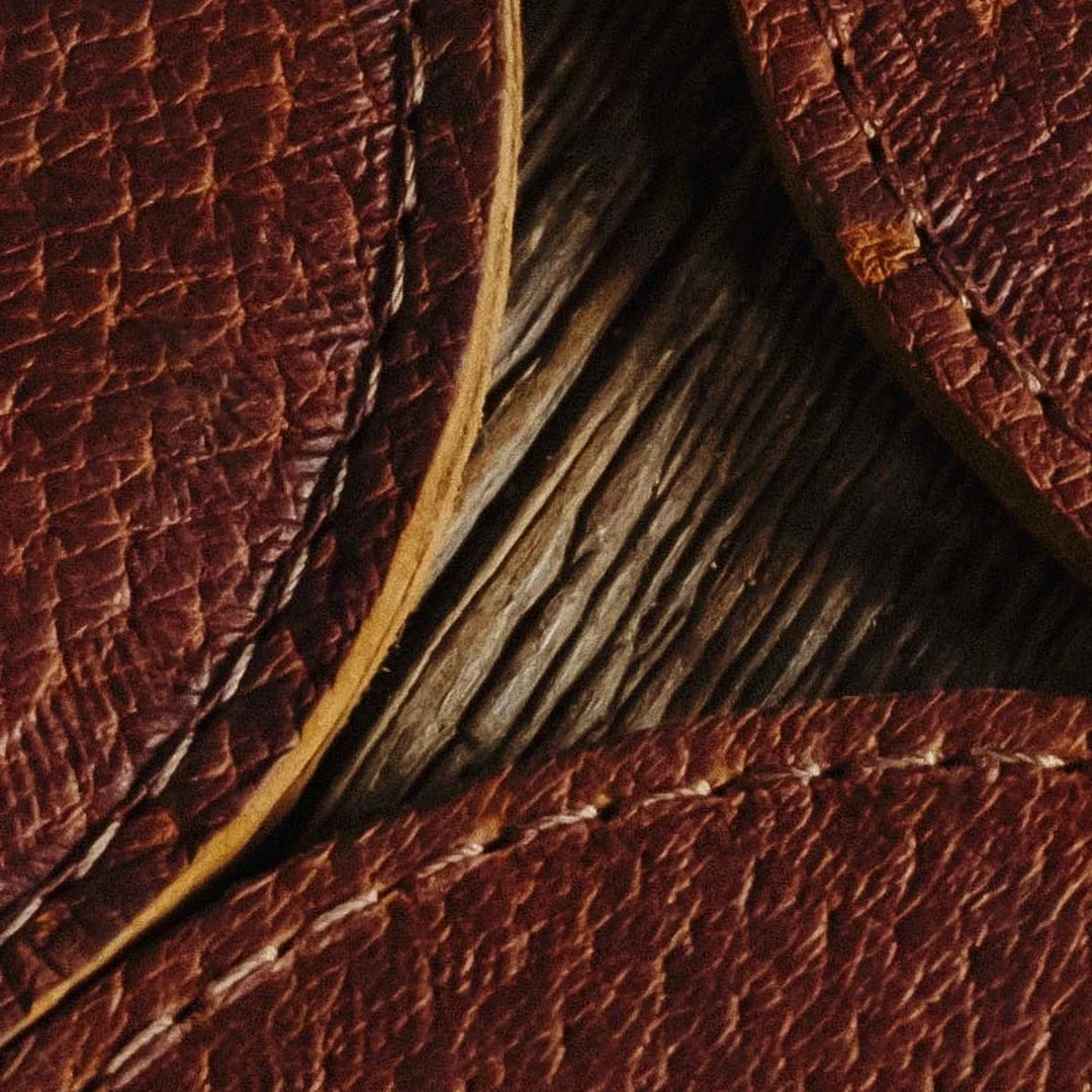 Close-up of Bad Leather Good's brown leather coasters with visible stitching