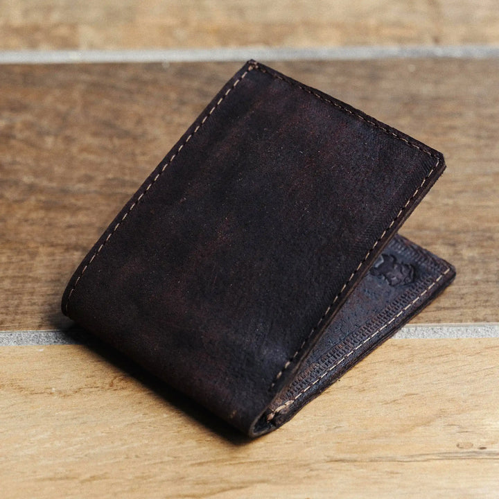 Dark leather wallet on a wooden surface