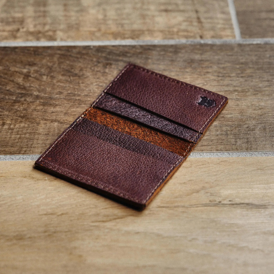 Brown leather wallet on a wooden surface