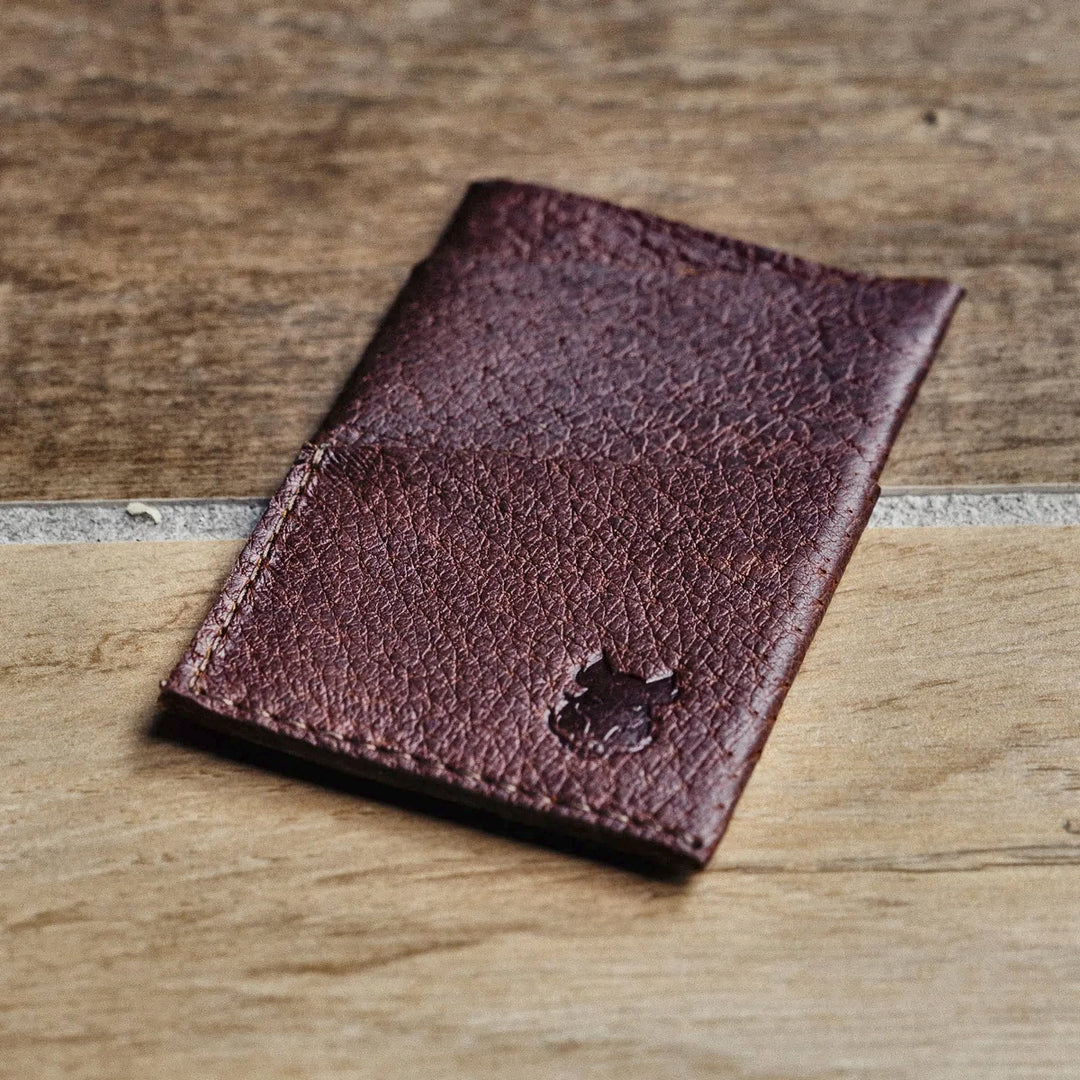 Brown leather  card wallet on a wooden surface