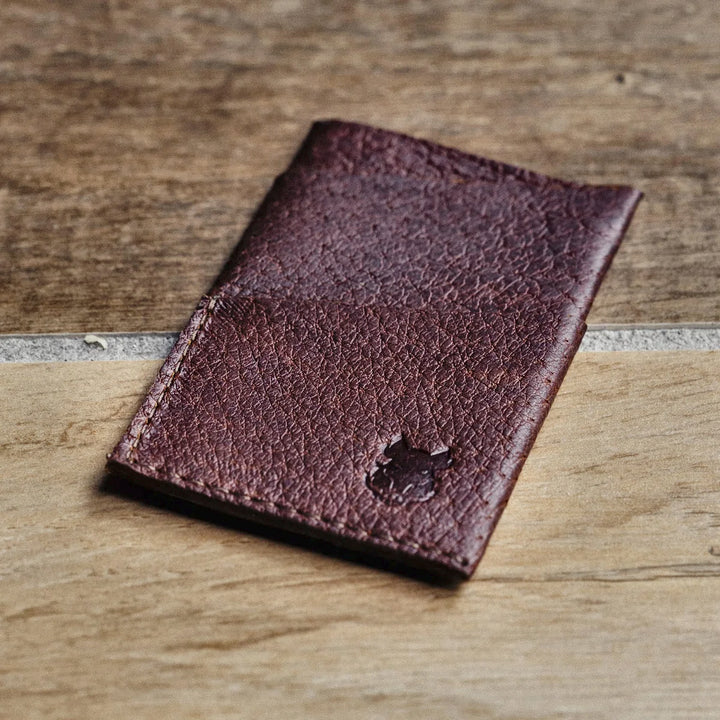 Brown leather  card wallet on a wooden surface