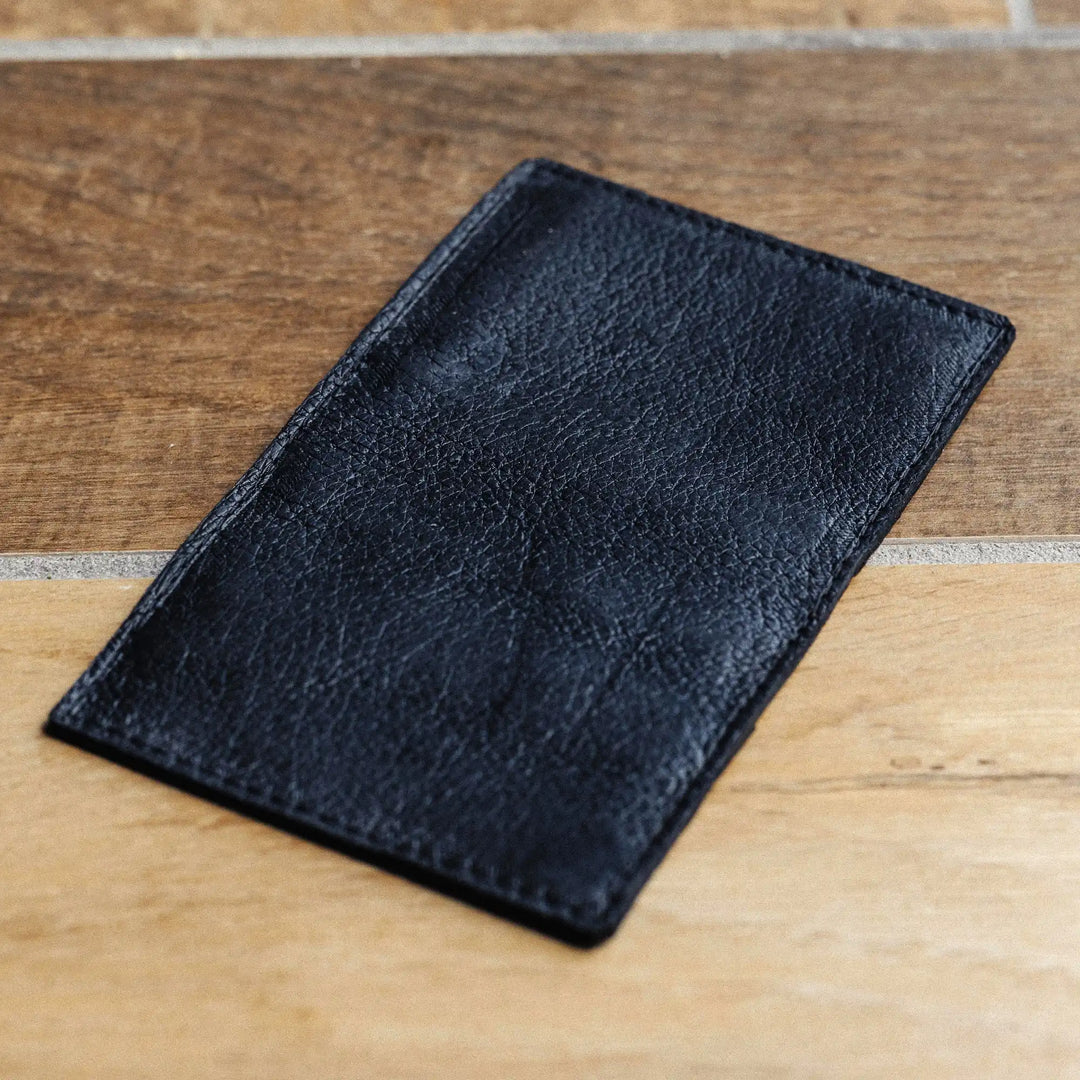 black leather wallet on a wooden surface