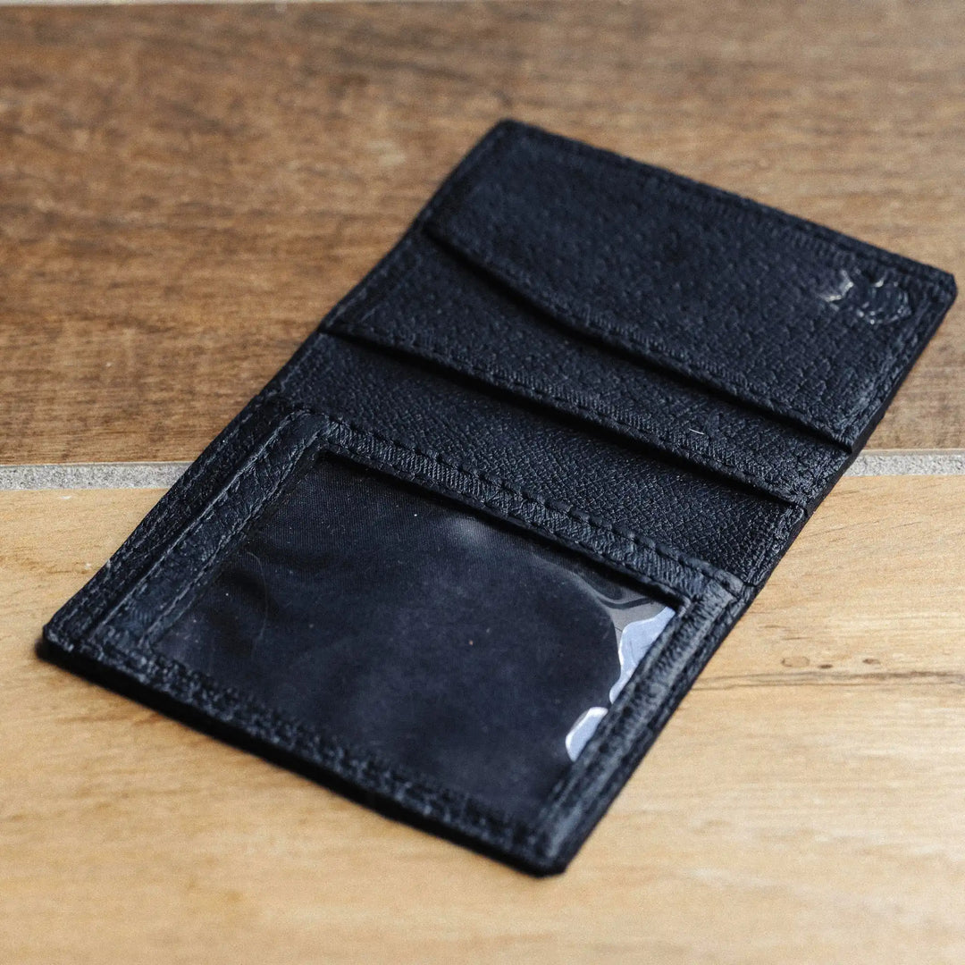 black leather wallet on a wooden surface